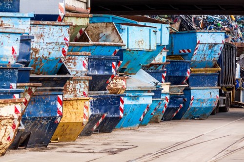 Business professionals handling waste removal in Kilburn office
